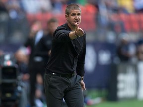 Vancouver Whitecaps' head coach Carl Robinson argues a call with the referee before being ejected from the pitch during first half MLS soccer action against the New York Red Bulls on Saturday.