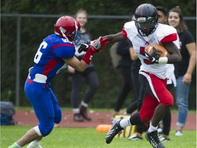 Abbotsford Panthers running back Samwell Uko evades Centennial Centaurs' Michael Vacchiano on his way to an 80-yard kick-off return touchdown Friday in Coquitlam. (Gerry Kahrmann, PNG photo)