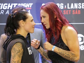 Brazil's Cristiane Justino, known as "Cris Cyborg," right, and Sweden's Lina Lansberg pose for photos on Thursday ahead of their bought on Saturday for UFC's Fight Night in Brasilia.