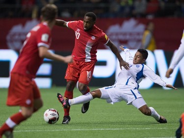 Canada's Junior Hoilett, centre, fights off a challenge from El Salvador's Oscar Ceren, right, to get the ball to teammate Nik Ledgerwood, front left, who sored on the play during second half FIFA World Cup qualifying soccer action in Vancouver, B.C., on Tuesday September 6, 2016.
