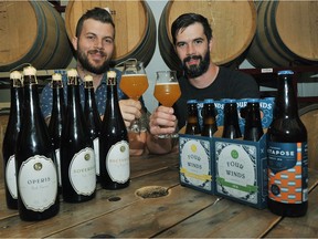 Adam Mills (left) and Brent Mills show off some of their award-winning Four Winds beers at the Delta brewery.