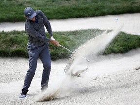 Rory McIlroy, of Northern Ireland, hits from a bunker on the 18th hole during the final round of the Deutsche Bank Championship golf tournament in Norton, Mass., Monday, Sept. 5, 2016.