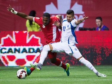 Canada's Doneil Henry, left, and El Salvador's Nelson Bonilla vie for the ball during first half FIFA World Cup qualifying soccer action in Vancouver, B.C., on Tuesday September 6, 2016.