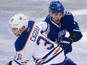 Drake Caggiula of the Oilers and Canucks prospect Troy Stecher battle it out for the preseason Hart Trophy.