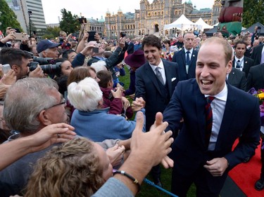 The Duke of Cambridge greets onlookers with Prime Minister Justin Trudeau in front of the Legislative Assembly in Victoria, B.C., on Saturday, September 24, 2016.