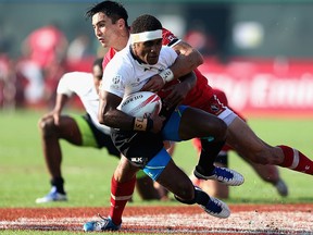 Emosi Mulevoro of Fiji is tackled by Sean Duke of Canada during the Emirates Dubai Rugby Sevens in December 2015 in the United Arab Emirates. Warren Little/Getty Images files