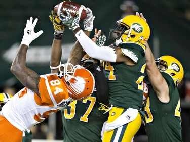 B.C. Lions' Emmanuel Arceneaux (84) tries to get the pass as Edmonton Eskimos Brandyn Thompson (24) makes the interception during second half CFL action in Edmonton, Alta., on Friday September 23, 2016.