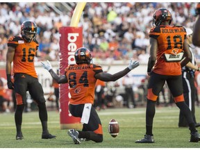 B.C. Lions wide receiver Emmanuel Arceneaux celebrates his touchdown against the Montreal Alouettes between teammates Bryan Burnham, left, and Geraldo Boldewijn during second quarter CFL football action Thursday, August 4, 2016 in Montreal.