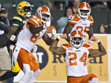 B.C. Lions' Emmanuel Arceneaux (84) and Jeremiah Johnson (24) celebrate a touchdown against the Edmonton Eskimos during first half CFL action in Edmonton, Alta., on Friday September 23, 2016.