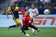Vancouver Whitecaps' Erik Hurtado, right, watches as his shot sails wide of the net behind New York Red Bulls' goalkeeper Luis Robles as Aurelien Collin, left, looks on during first half MLS soccer action in Vancouver, Saturday, September 3, 2016.