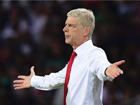 Arsenal's French manager Arsene Wenger gestures during the UEFA Champions League Group A match between Paris-Saint-Germain and Arsenal FC on Sept. 13, 2016, at the Parc des Princes stadium in Paris.
