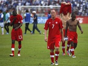 Followed by teammates, Canada's Iain Hume, front, at the end of a 2014 World Cup qualifying soccer match against Honduras in San Pedro Sula, Honduras on Oct 16, 2012.