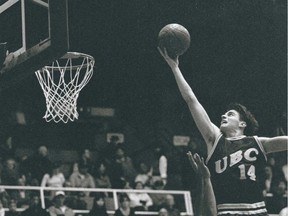 John Dumont, wearing No. 14, extends for a layup as he drives the basket during his playing days with the  UBC Thunderbirds.