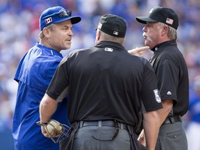 Blue Jays manager John Gibbons argues with umpire crew chief Jim Joyce, right, and home plate um Marvin Hudson before being ejected during the ninth inning against the Boston Red Sox in Toronto on Sept. 11.