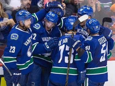 Vancouver Canucks' Alexander Edler, of Sweden, from left to right, Joseph Labate, Alexis D'Aoust, James Sheppard and Troy Stecher celebrate Labate's goal against the Edmonton Oilers during the second period of a pre-season NHL hockey game in Vancouver, B.C., on Wednesday September 28, 2016.