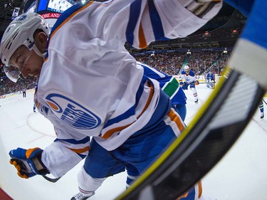Edmonton Oilers' Anton Slepyshev, of Russia, is checked by Vancouver Canucks' James Sheppard, back, during the first period of a pre-season NHL hockey game in Vancouver, B.C., on Wednesday September 28, 2016.