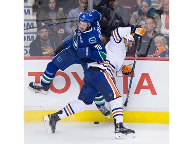 Vancouver Canucks' James Sheppard, left, checks Edmonton Oilers' Patrick Maroon during the third period of a pre-season NHL hockey game in Vancouver, B.C., on Wednesday September 28, 2016.