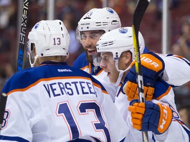 Edmonton Oilers' Drake Caggiula, right, Patrick Maroon, centre, and Kris Versteeg celebrate Caggiula's goal against the Vancouver Canucks during the first period of a pre-season NHL hockey game in Vancouver, B.C., on Wednesday September 28, 2016.