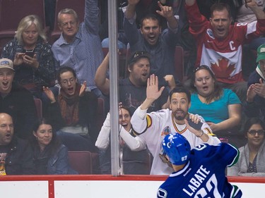 Fans join in on the celebration after Vancouver Canucks' Joseph Labate scored against the Edmonton Oilers during the second period of a pre-season NHL hockey game in Vancouver, B.C., on Wednesday September 28, 2016.