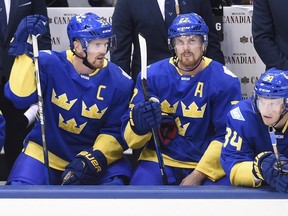 Henrik Sedin, Daniel Sedin and Carl Soderberg