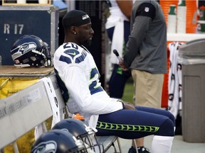 Seattle Seahawks cornerback Jeremy Lane sits as the national anthem plays before a preseason NFL football game against the Oakland Raiders, Thursday, Sept. 1, 2016, in Oakland, Calif.