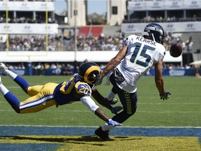 Seattle Seahawks wide receiver Jermaine Kearse, right, can't hold on to a pass in the endzone while under pressure from Los Angeles Rams cornerback Lamarcus Joyner during the first half an NFL football game at the Los Angeles Memorial Coliseum, Sunday, Sept. 18, 2016, in Los Angeles.