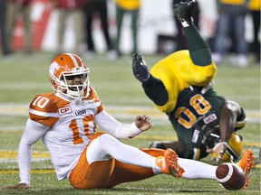 B.C. Lions quarterback Jonathon Jennings (10) is sacked by Edmonton Eskimos Almondo Sewell (90) during second half CFL action in Edmonton, Alta., on Friday September 23, 2016.