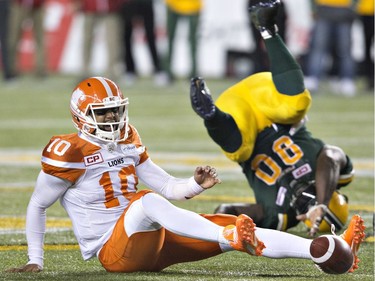 B.C. Lions quarterback Jonathon Jennings (10) is sacked by Edmonton Eskimos Almondo Sewell (90) during second half CFL action in Edmonton, Alta., on Friday September 23, 2016.