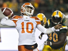 B.C. Lions quarterback Jonathon Jennings (10) makes a pass as he is chased by Edmonton Eskimos' Almondo Sewell (90) during first half CFL action in Edmonton, Alta., on Friday.