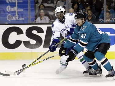 Vancouver Canucks' Jordan Subhan, left, passes next to San Jose Sharks' Joakim Ryan (47) during the second period of an NHL preseason hockey game Tuesday, Sept. 27, 2016, in San Jose, Calif.