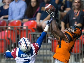 B.C. Lions' Emmanuel Arceneaux, right, makes a reception in the end zone for a touchdown as Montreal Alouettes' Jovon Johnson defends during the first half of Friday's game. Despite the quality of their on-field product, the Lions are still seeing a sea of empty seats at B.C. Place.