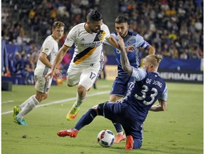 Whitecaps defender Marcel de Jong, right, battles against the Los Angeles Galaxy Aug. 27. De Jong, who played 13 games for Kansas City in 2015, is expected to start for Vancouver there tonight.