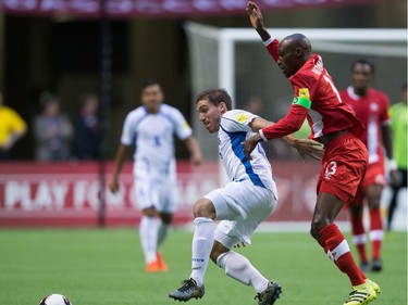 El Salvador's Pablo Punyed, left, and Canada's Atiba Hutchinson vie for the ball during first half FIFA World Cup qualifying soccer action in Vancouver, B.C., on Tuesday September 6, 2016.