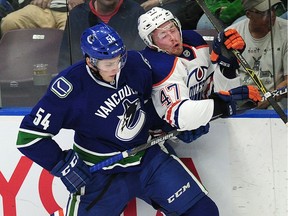 PENTICTON, BC., September 16, 2016 -- Vancouver Canucks' Guilaume Brisebois (54) against the boards with  Edmonton Oilers' Joey Benik (47) during second period 2016 NHL Young Stars Classic action at the South Okanagan Events Centre in Penticton, BC., September 16, 2016.   (NICK PROCAYLO/PostMedia)  00045178A   [PNG Merlin Archive]