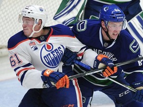 Vancouver Canucks' Tate Olson (64) in front of the goal with Edmonton Oilers' Braden Christoffer (61) during second period 2016 NHL Young Stars Classic action at the South Okanagan Events Centre in Penticton, BC., September 16, 2016.   (NICK PROCAYLO/PostMedia)  00045178A   [PNG Merlin Archive]