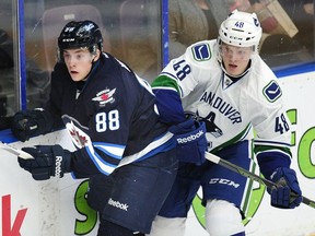 Vancouver Canucks' Olli Juolevi (78) on the boards with Winnipeg Jets' Antoine Waked (88) during first period 2016 NHL Young Stars Classic action at the South Okanagan Events Centre in Penticton.