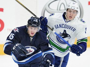 Vancouver Canucks Troy Stecher (51) chases Winnipeg Jets Jikky Lodge (45) during the first period of the NHL Young Stars tournament at the South Okanagan Events Centre in Penticton on Sunday. NICK PROCAYLO/PNG