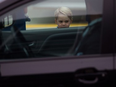 Prince George waits to get into a vehicle with his parents and sister after the royal family's arrival in Victoria, B.C., on Saturday, September 24, 2016.