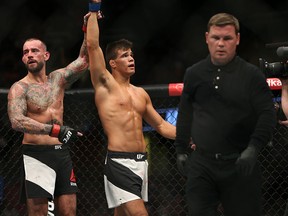 Mickey Gall celebrates his victory over CM Punk, left, Saturday at UFC 203 in Cleveland.