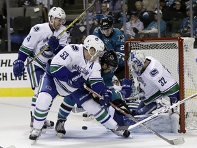 Vancouver Canucks goalie Richard Bachman (32) blocks a shot against the San Jose Sharks during the first period of an NHL preseason hockey game Tuesday, Sept. 27, 2016, in San Jose, Calif.