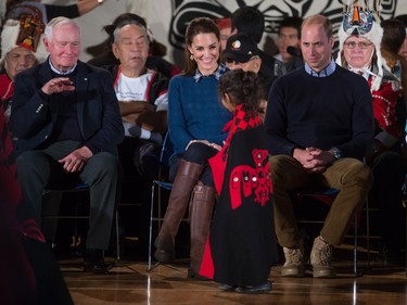 A young first nations girl walks past Britain's Prince William, the Duke of Cambridge, and Kate, the Duchess of Cambridge, and Governor General David Johnson, left, during a welcoming ceremony at the Heiltsuk First Nation in the remote community of Bella Bella, B.C., on Monday September 26, 2016.