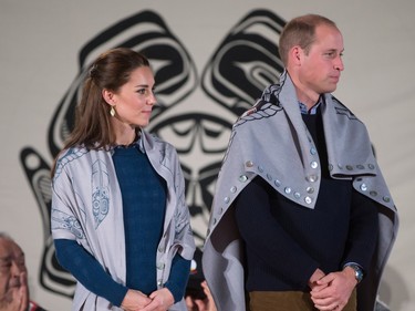 Britain's Prince William, the Duke of Cambridge, and Kate, the Duchess of Cambridge, stand together after being draped in traditional First Nation blankets during a welcoming ceremony at the Heiltsuk First Nation in the remote community of Bella Bella, B.C., on Monday September 26, 2016.