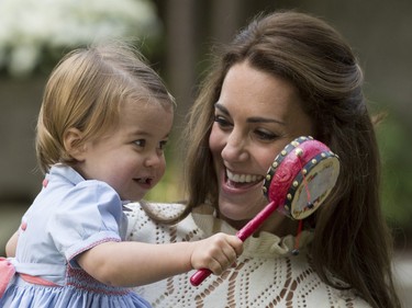The Duchess of Cambridge holds Princess Charlotte during a children's party in Victoria, B.C. Thursday, Sept 29, 2016.