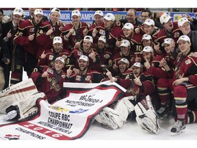 The West Kelowna Warriors pose with their championship banner and trophy after winning the 2016 Royal Bank Cup in Lloydminster Alta. on Sunday May 22, 2016. The Warriors defeated the Lloydminster Bobcats 4-0.