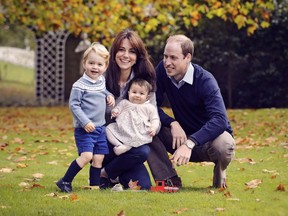 This photo released by Kensington Palace on Friday Dec. 18, 2015 shows The Duke and Duchess of Cambridge with their two children, Prince George and Princess Charlotte, in a photograph taken late October 2015 at Kensington Palace in London.