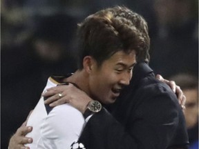 Tottenham's Son Heung-min is hugged by Tottenham's manager Mauricio Pochettino after he scored 1-0 during the Champions League Group E soccer match between CSKA Moscow and Tottenham Hotspur, in Moscow, Russia, Tuesday, Sept. 27, 2016.