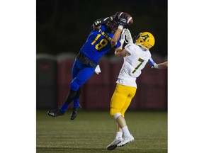UBC Thunderbirds' free safety Stavros Katsantonis gets airborne to beat Alberta wide receiver Peter Zajdel for an interception last Saturday in Vancouver. (Richard Lam/UBC athletics) [PNG Merlin Archive]
