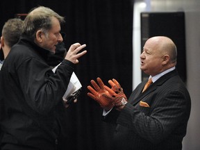 The Province's Lowell Ullrich discusses orange gloves with B.C. Lions president Dennis Skulsky in 2012.