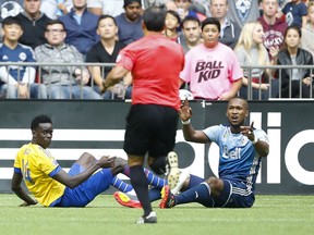 MLS referee Baldomero Toledo calls a penalty kick on Vancouver Whitecaps defender Kendall Waston, right, after Waston took down Colorado Rapids forward Dominique Badji in the box during the second half at B.C. Place on Saturday. Waston was red-carded and ejected from the game, which ended in a 3-3 draw.