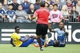 MLS referee Baldomero Toledo calls a penalty kick on Vancouver Whitecaps defender Kendall Waston, right, after Waston took down Colorado Rapids forward Dominique Badji in the box during the second half at B.C. Place on Saturday. Waston was red-carded and ejected from the game, which ended in a 3-3 draw.